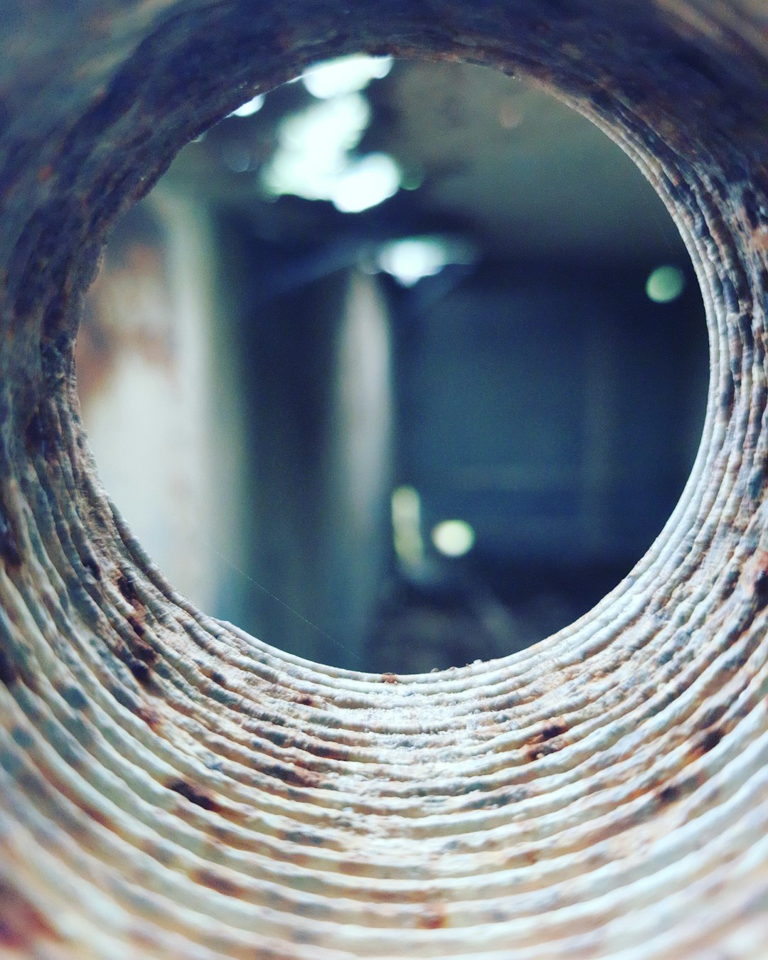 a-round-hole-in-a-brick-wall-with-a-blurry-background-srrtemrtjxs